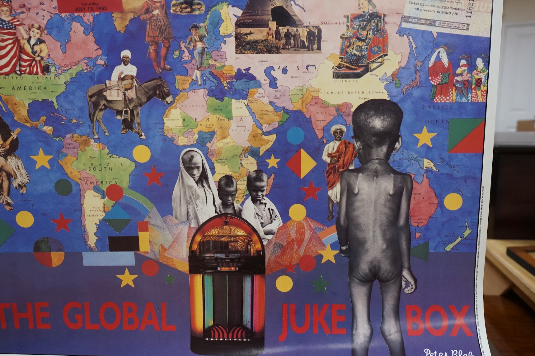 An original Live Aid poster, dated July 13th, 1985, and promoting the concerts at Wembley Stadium London, and John F. Kennedy Stadium Philadelphia, designed by Peter Blake, with photography by David Bailey and printed in